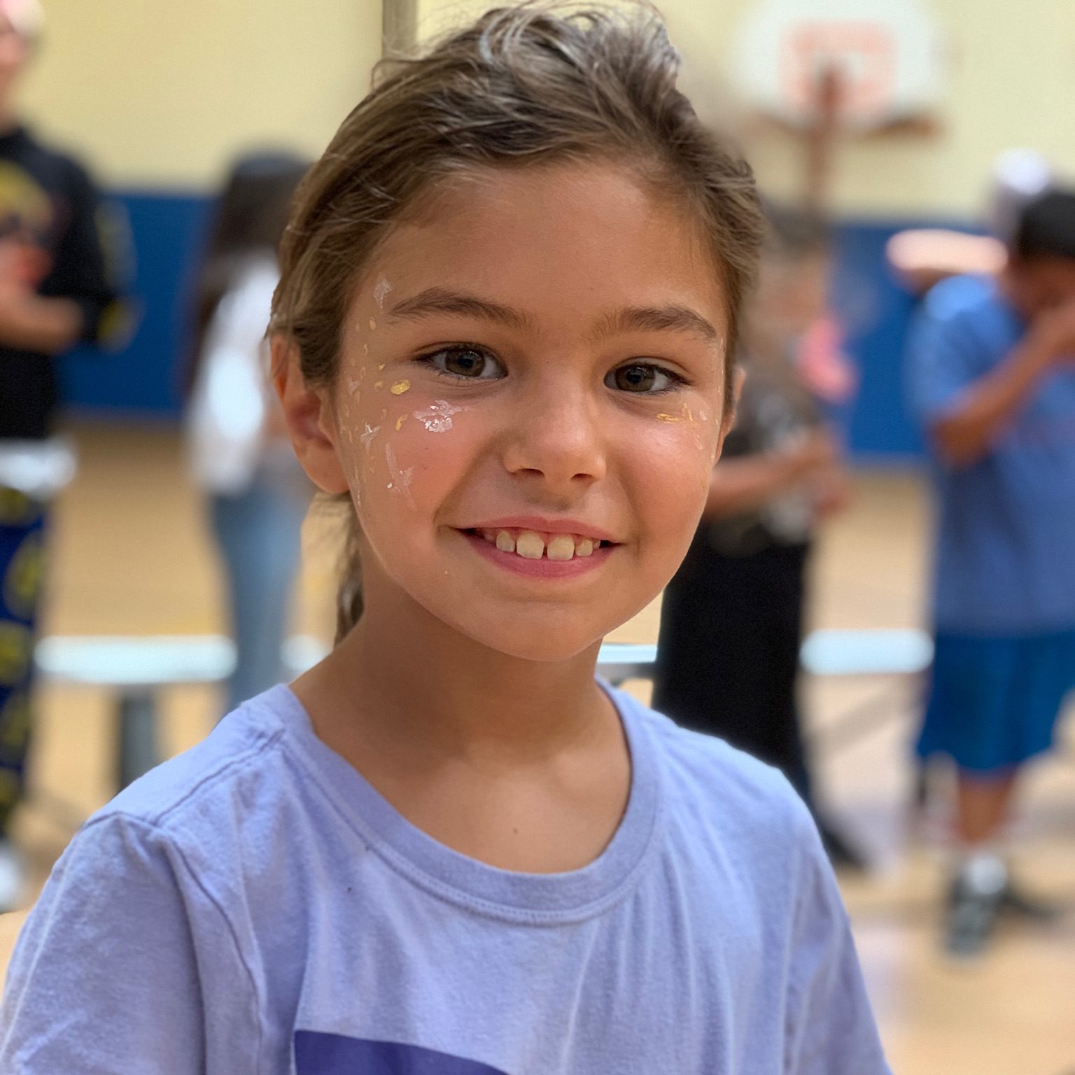 Young girl with faintly painted stars on face