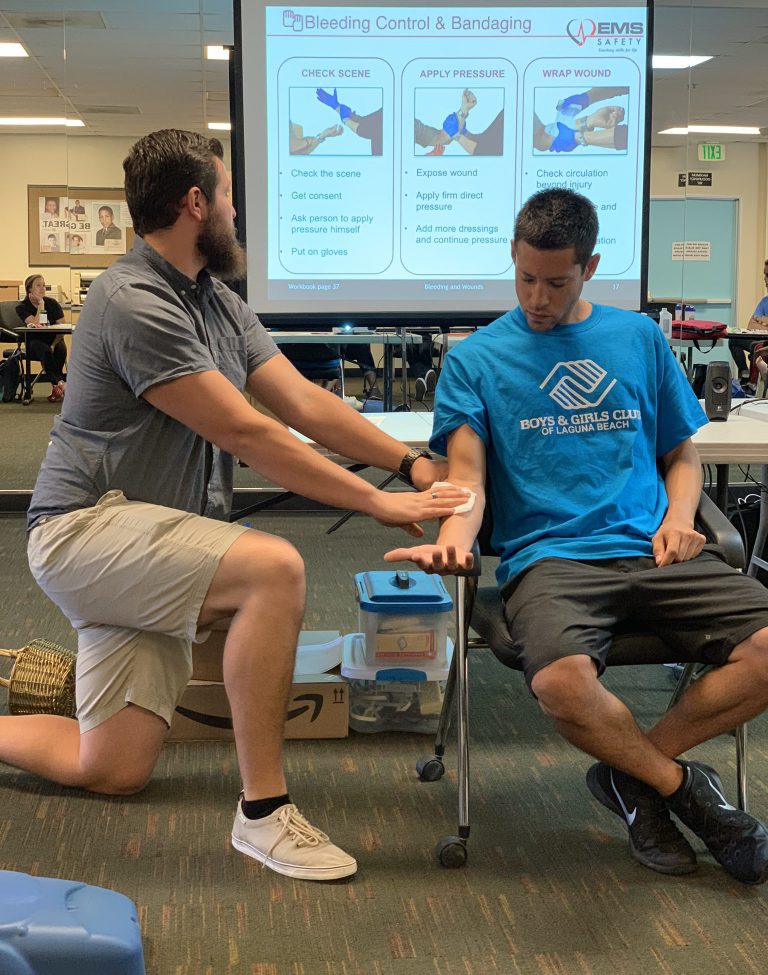 2 young adult men volunteers learning first-aid treatments