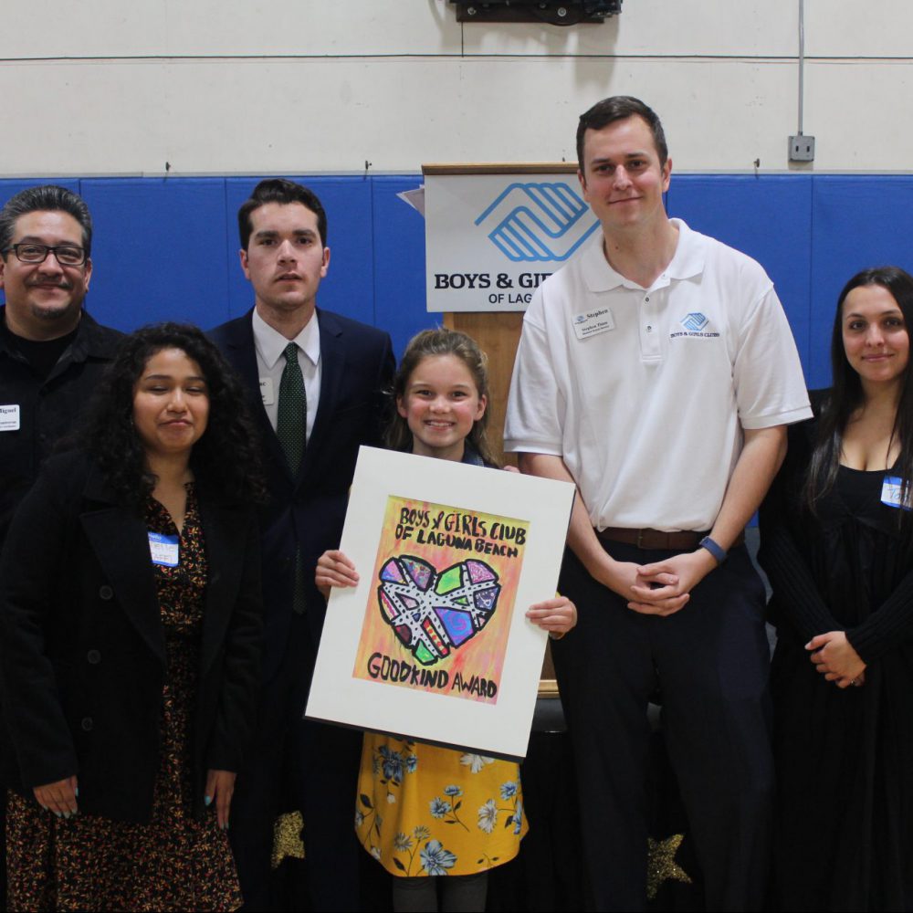 Becoming a leader group photo of young artist holding her Good Kind Award artwork