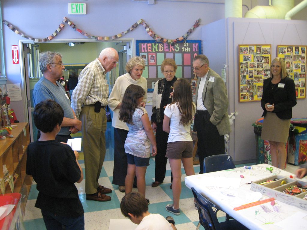 older people talking to kids while taking a tour of the Canyon Enrichment center
