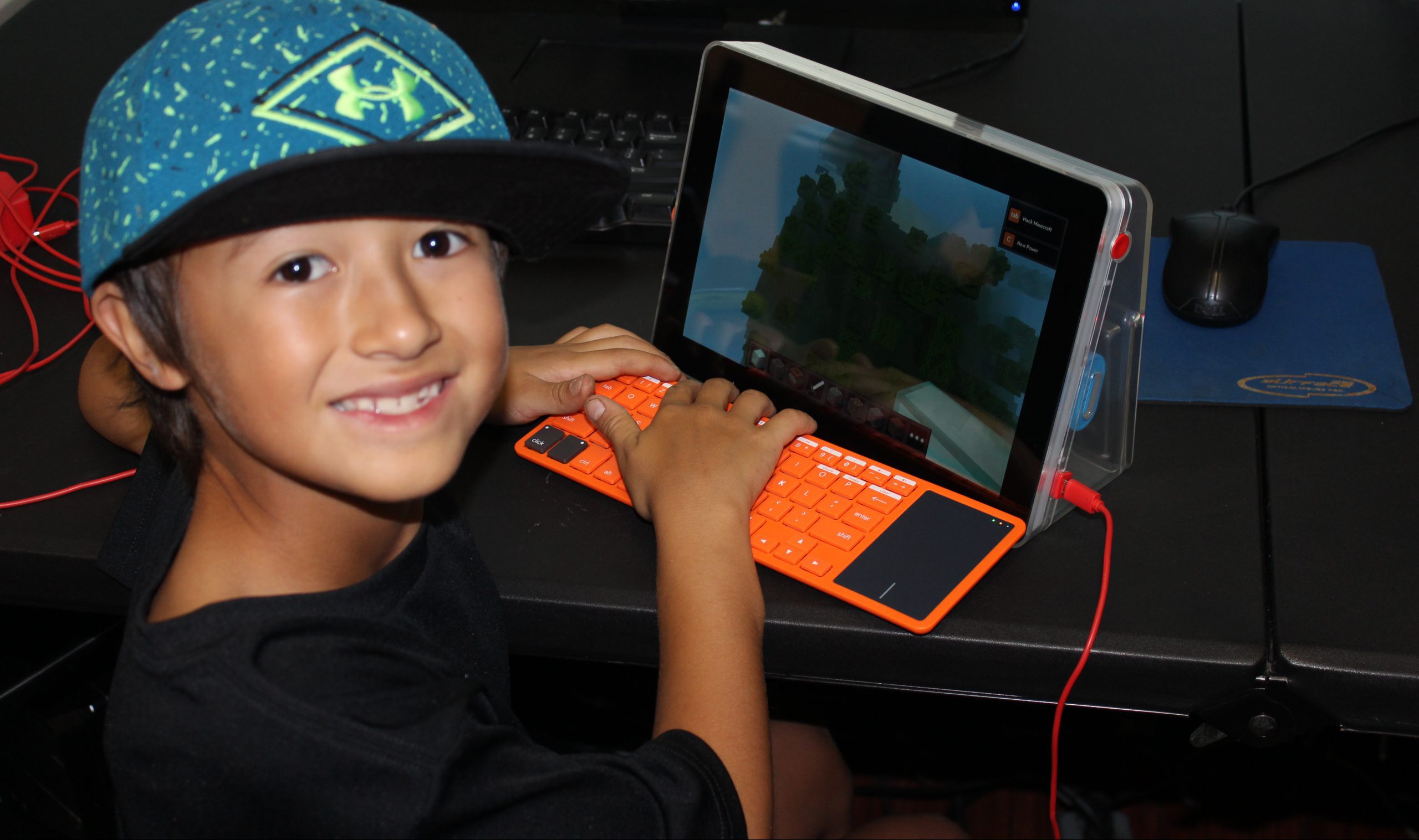 young boy playing a game on a ipad with keyboard