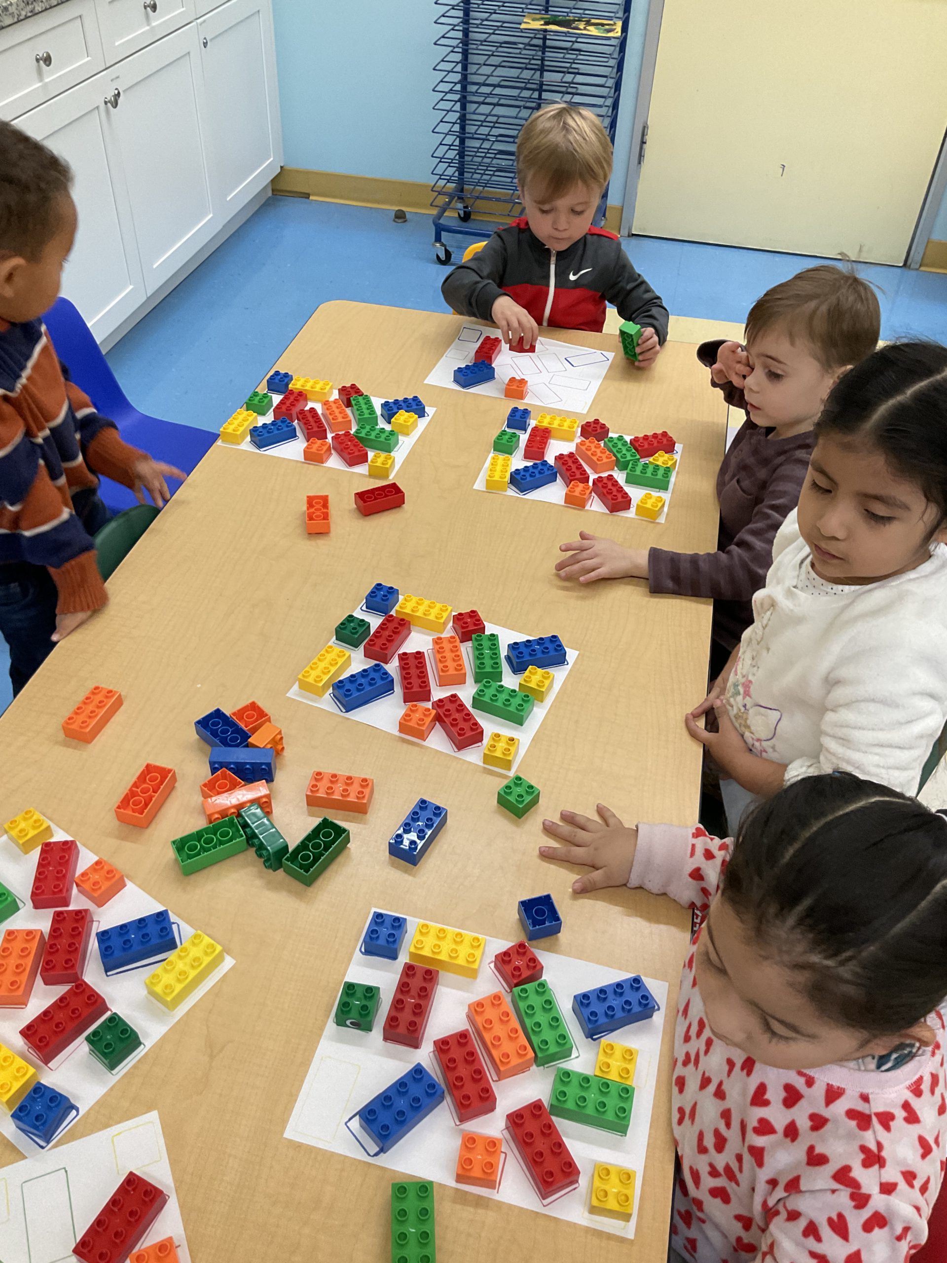 Preschool Children playing with blocks on tables