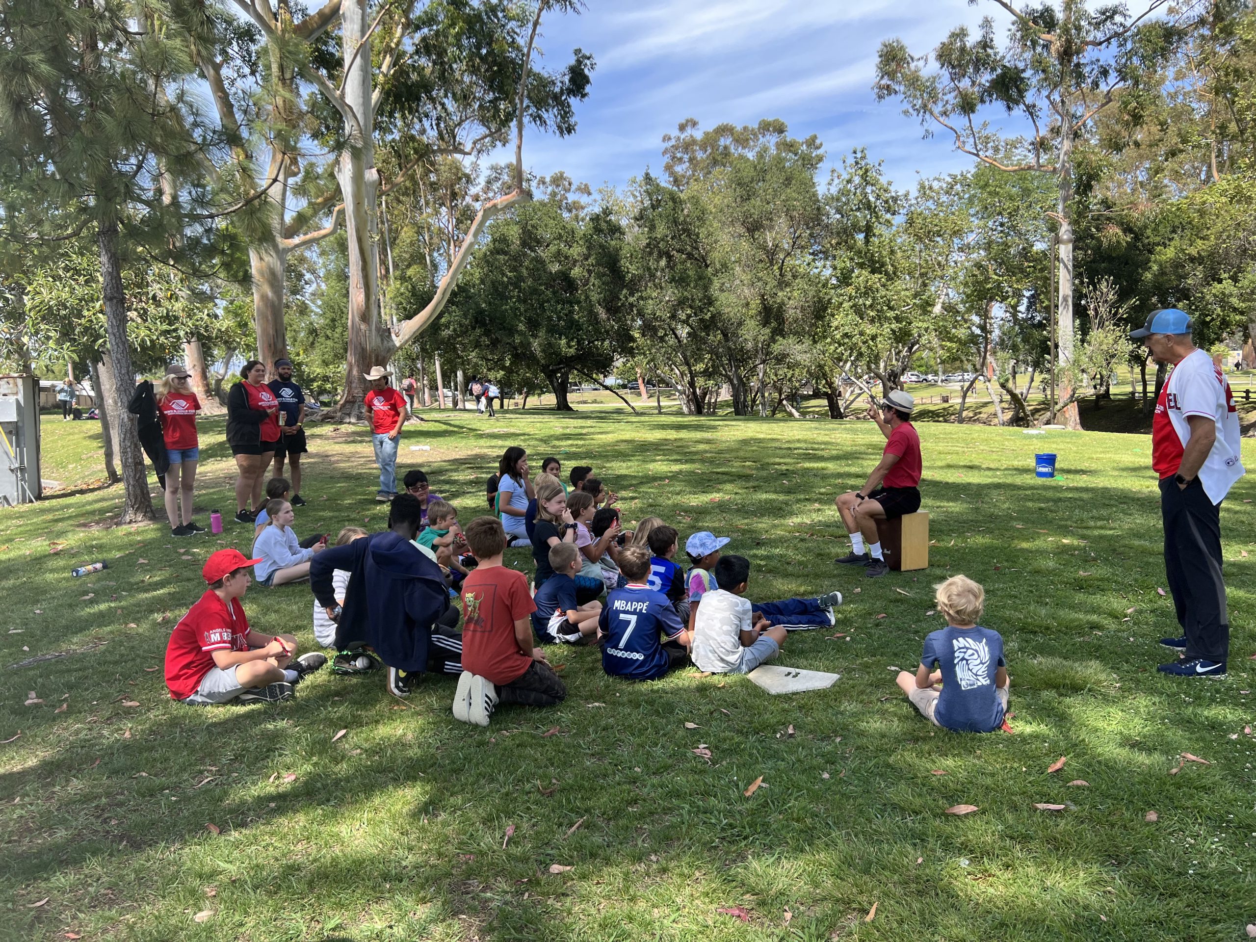 BGCLB El Toro Park Members sitting on the grass during programming